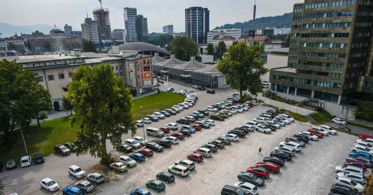 Aerial view of the large open-air parking lot (Parkirišče GR) next to the Ljubljana Exhibition and Convention Centre, with the Ljubljana city skyline in the background.