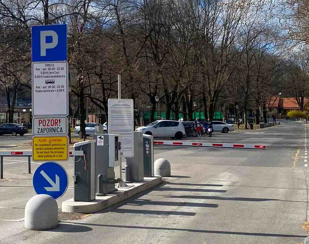 Entrance barrier and pricing signs at the outdoor Tivoli parking lot (Parkirišče Tivoli I) next to Tivoli Park in Ljubljana, Slovenia.